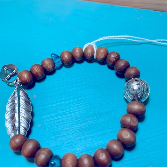 Wood bead bracelet with feather and heart lock. Stretchy one size boho vibe. - Picture 2 of 7